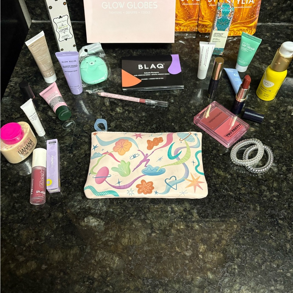 NWOT  Mystery Colorful Pouch with assorted cosmetics.